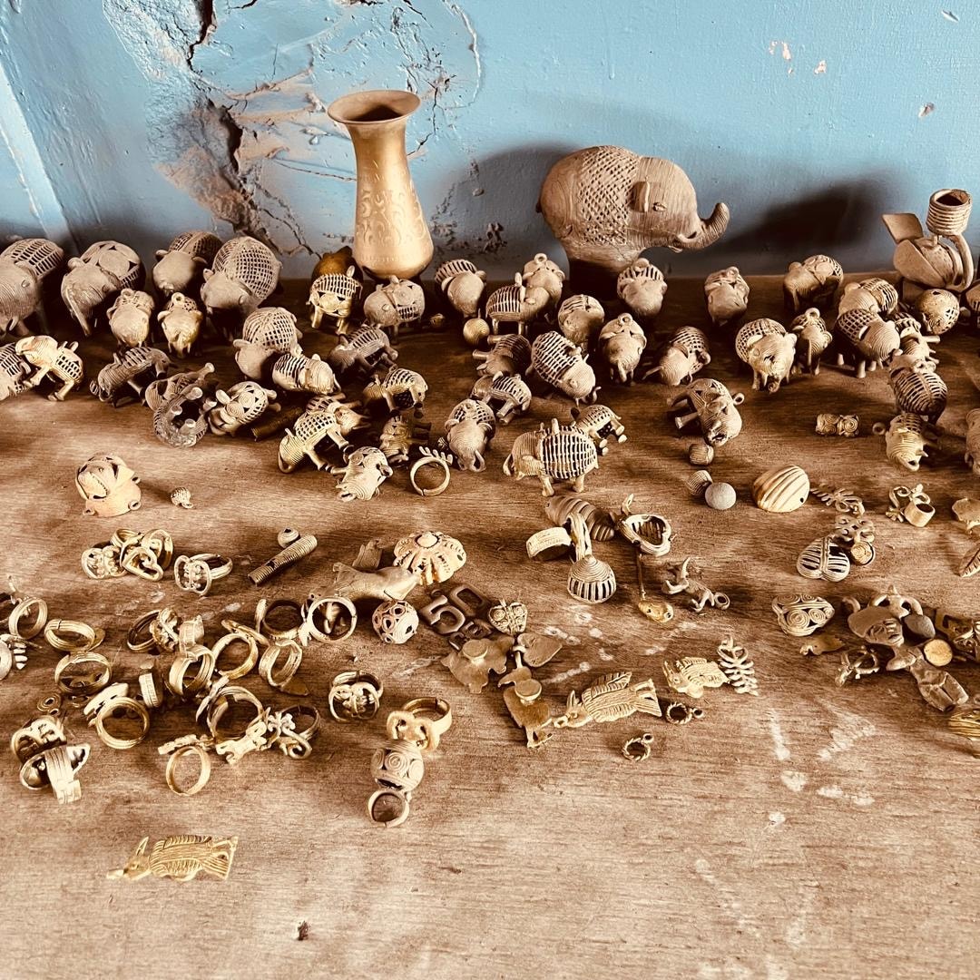 A collection of brass castings displayed on a workshop table